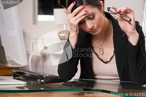 Image of Business Woman Office Manager Rubs Head Depression Sadness