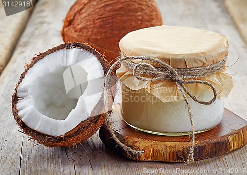 Image of jar of coconut oil and fresh coconuts