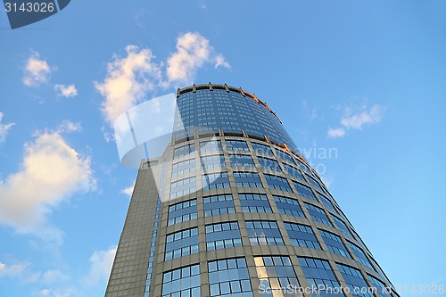 Image of Office modern building against the evening sky with white clouds