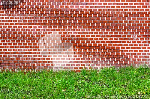 Image of Brick wall and green grass