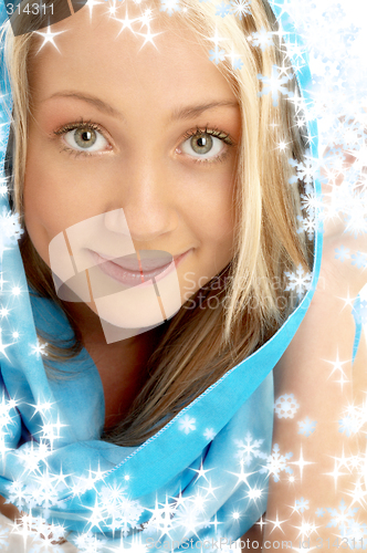 Image of smiling blond in blue scarf with snowflakes