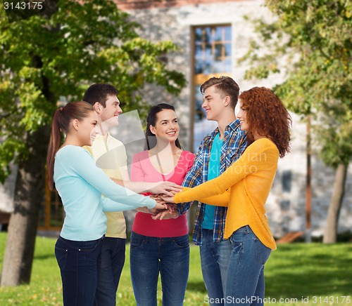 Image of group of smiling teenagers over campus background