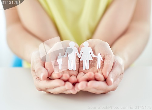 Image of close up of woman and girl hands with paper family