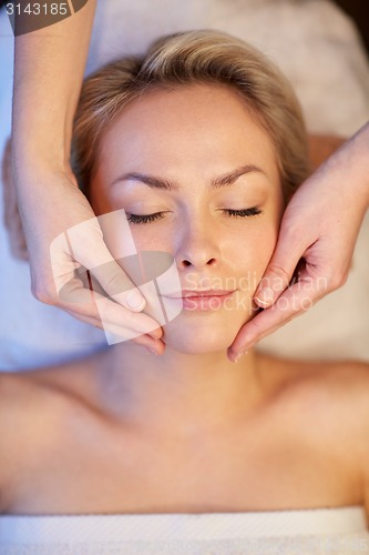 Image of close up of woman having face massage in spa