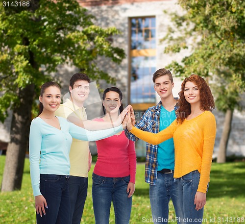 Image of group of smiling teenagers over campus background