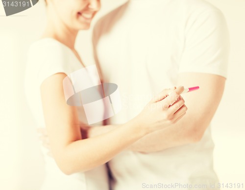 Image of woman and man hands with pregnancy test