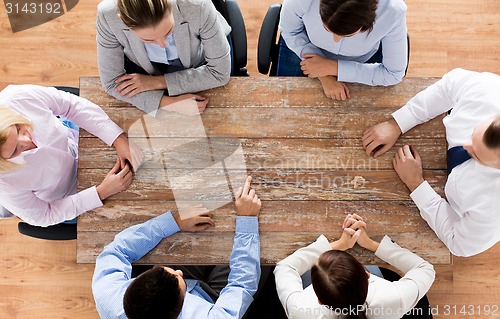 Image of close up of business team sitting at table