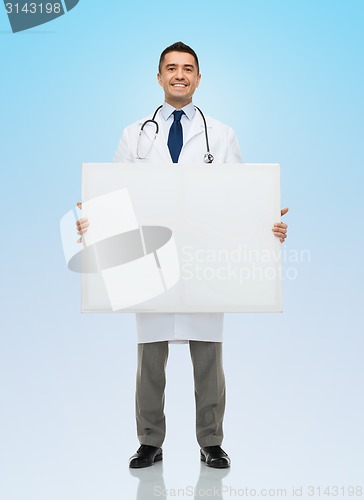 Image of smiling male doctor holding white blank board