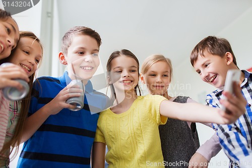 Image of group of school kids with smartphone and soda cans