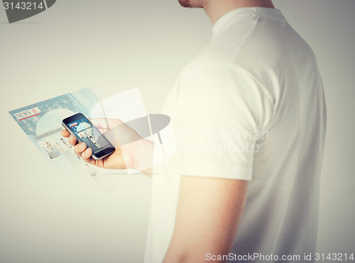 Image of man with smartphone reading news