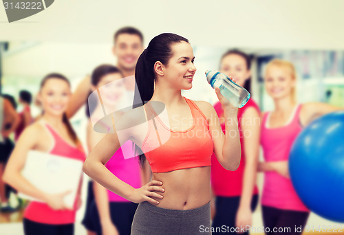 Image of sporty woman with water bottle