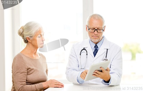 Image of senior woman and doctor with tablet pc