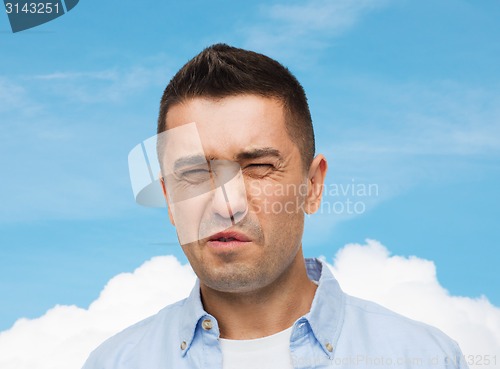 Image of man wrying of unpleasant smell