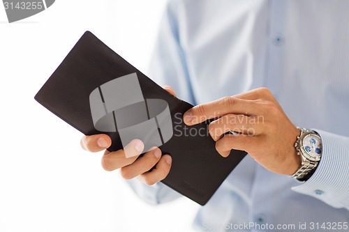 Image of close up of businessman hands holding open wallet