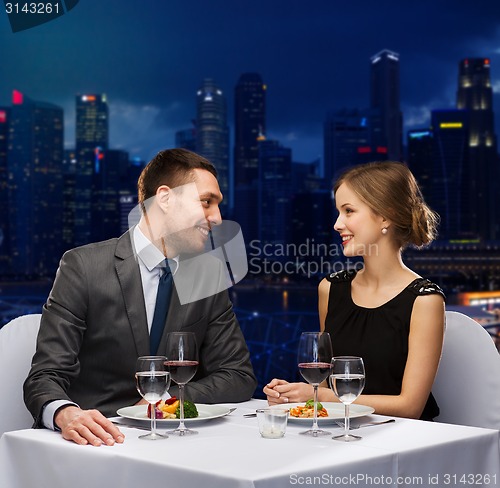 Image of smiling couple talking at restaurant