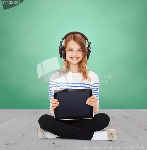 Image of happy girl with headphones showing tablet pc