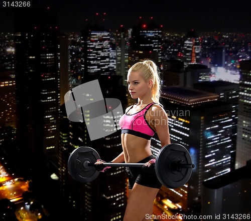 Image of sporty woman exercising with barbell