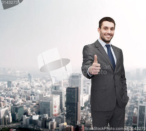 Image of handsome buisnessman showing thumbs up