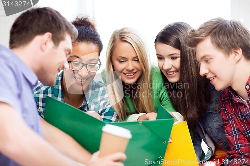 Image of students looking at notebook at school