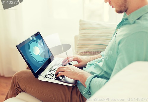 Image of close up of man working with laptop at home