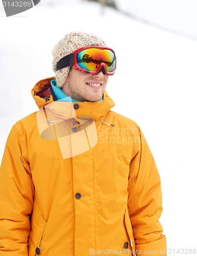 Image of happy young man in ski goggles outdoors