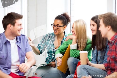 Image of students communicating and laughing at school