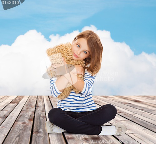 Image of cute little girl hugging teddy bear