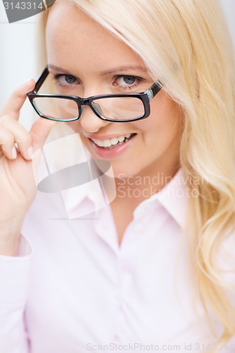 Image of smiling businesswoman or secretary in office