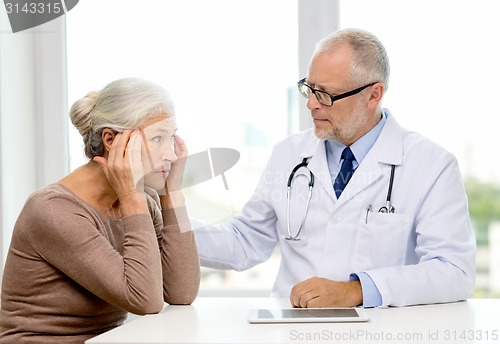 Image of senior woman and doctor with tablet pc