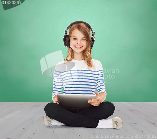 Image of happy school girl with headphones and tablet pc