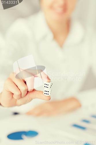 Image of man hands with gambling dices signing contract