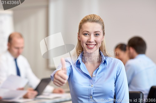 Image of group of smiling businesspeople meeting in office