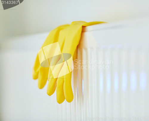 Image of close up of rubber gloves hanging on heater