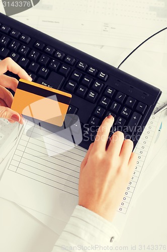 Image of businesswoman with laptop using credit card