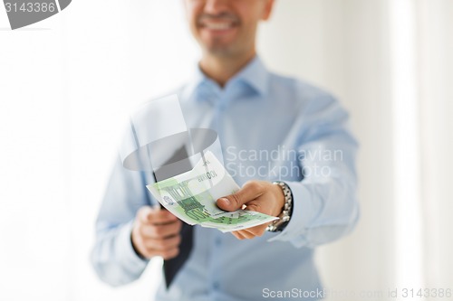 Image of close up of businessman hands holding money