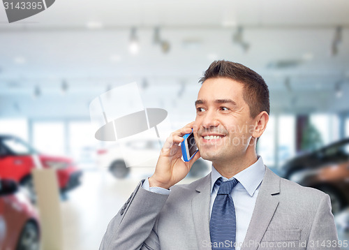 Image of happy businessman calling on smartphone