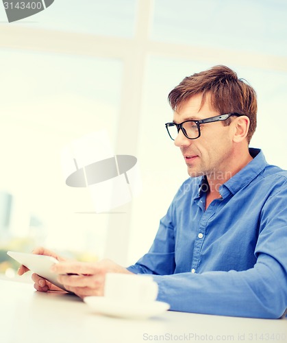 Image of man working with tablet pc at home