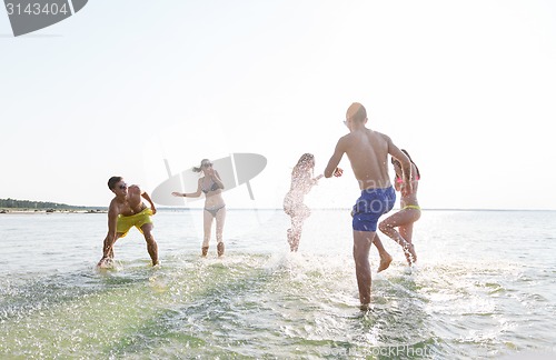 Image of happy friends having fun on summer beach