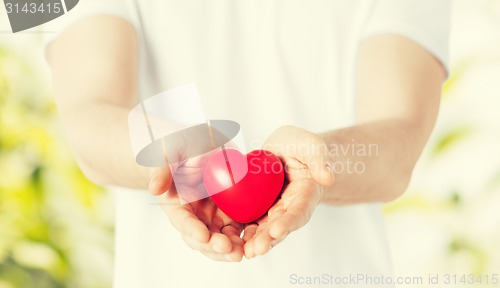 Image of man hands with heart
