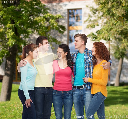 Image of group of smiling teenagers over campus background