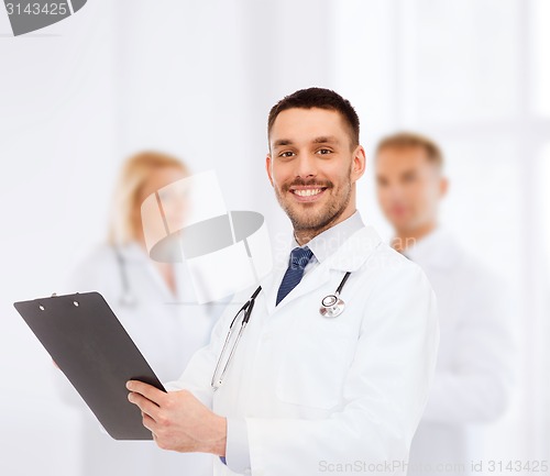 Image of smiling male doctor with clipboard and stethoscope