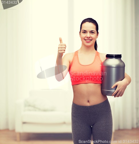 Image of teenage girl with jar of protein showing thumbs up