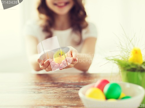 Image of close up of girl holding yellow chiken toy