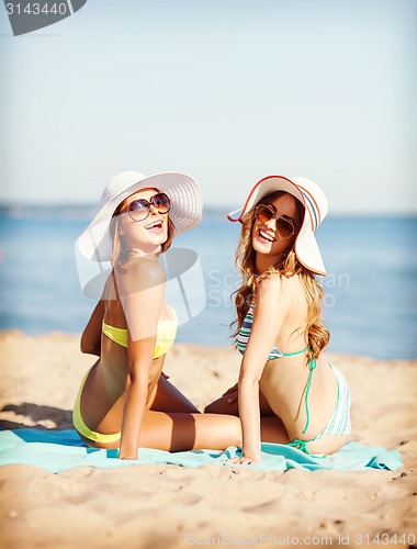 Image of girls sunbathing on the beach