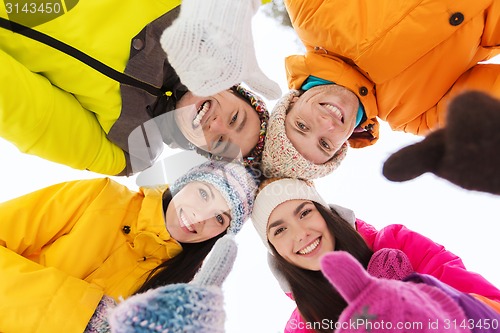 Image of happy friends in winter clothes outdoors