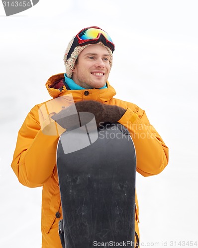 Image of happy young man in ski goggles outdoors