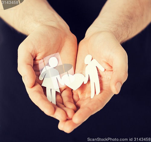 Image of man hands with paper men