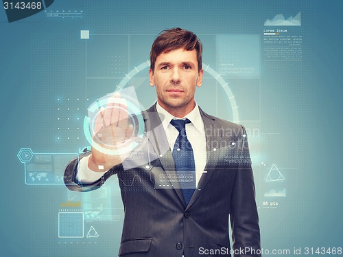 Image of attractive buisnessman wotking with virtual screen