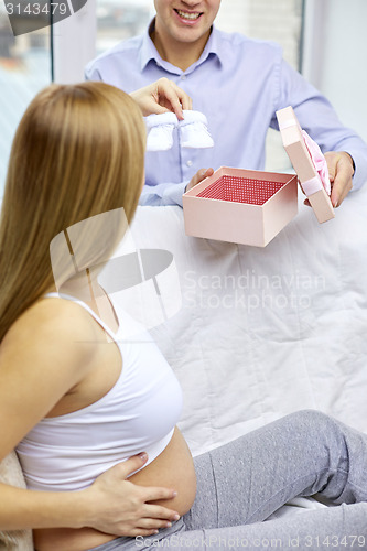 Image of close up of pregnant woman and man with bootees