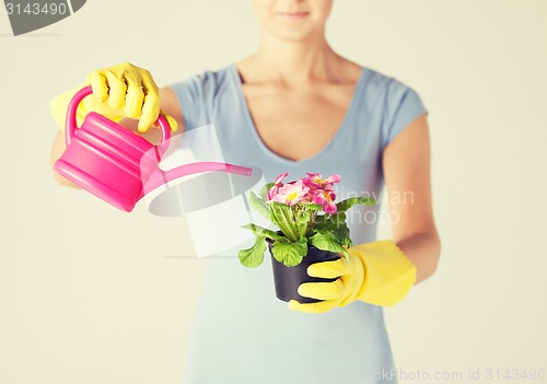 Image of woman holding pot with flower